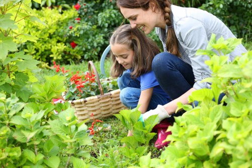 Trainer demonstrating safe tool use during garden care training
